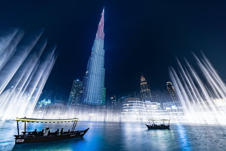 Experience the dazzling light and water displays of the Dubai Fountain while gliding peacefully on a traditional abra surrounded by iconic landmarks and shimmering reflections.